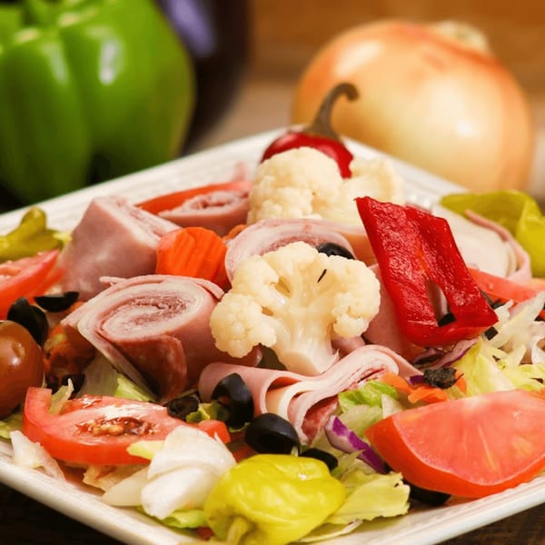 Ameci Pizza & Pasta's antipasto salad with ham, salami, provolone, olives, tomatoes, and peppers.